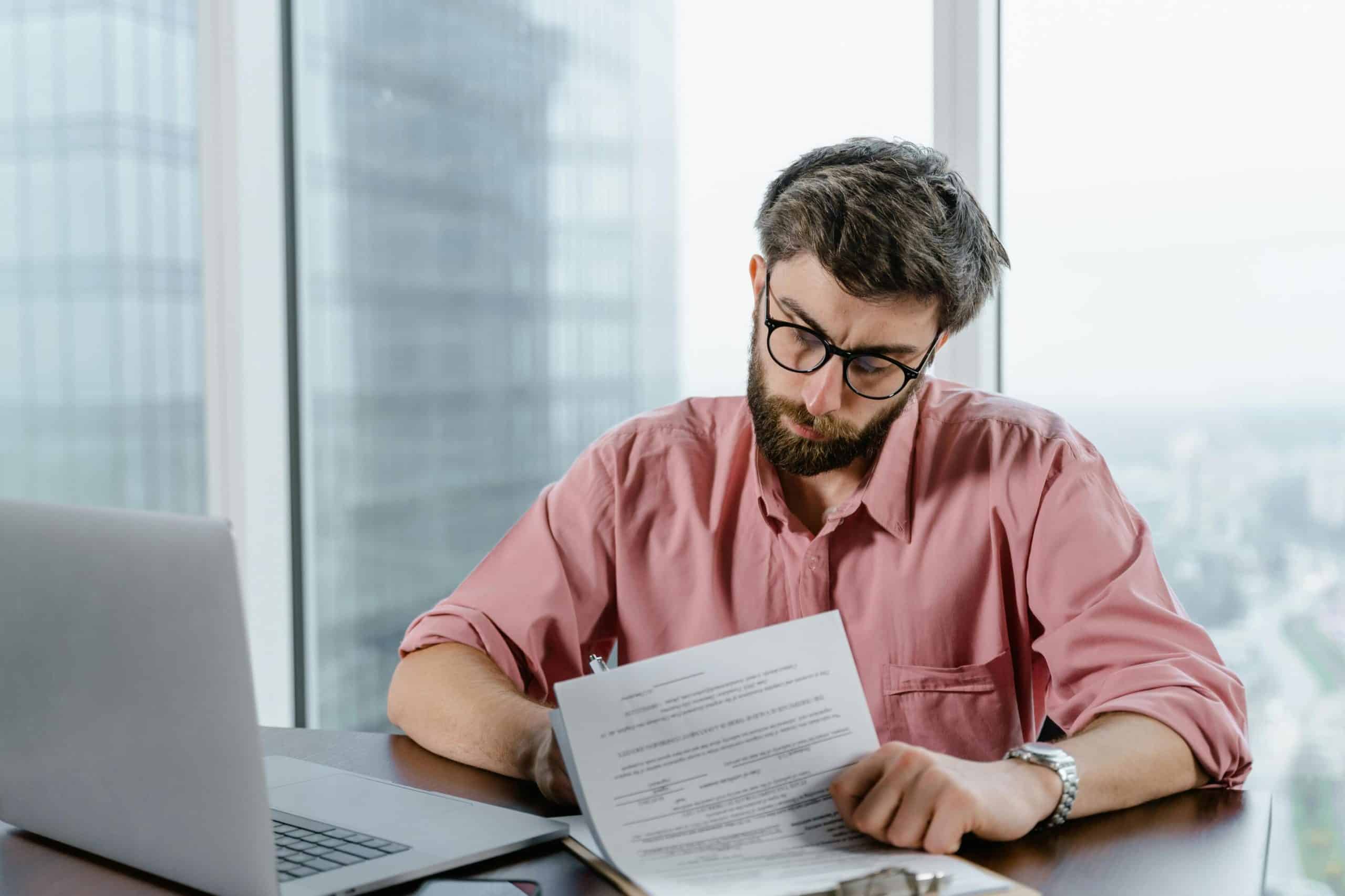 A Texas real estate agent reviewing paperwork at a desk.
